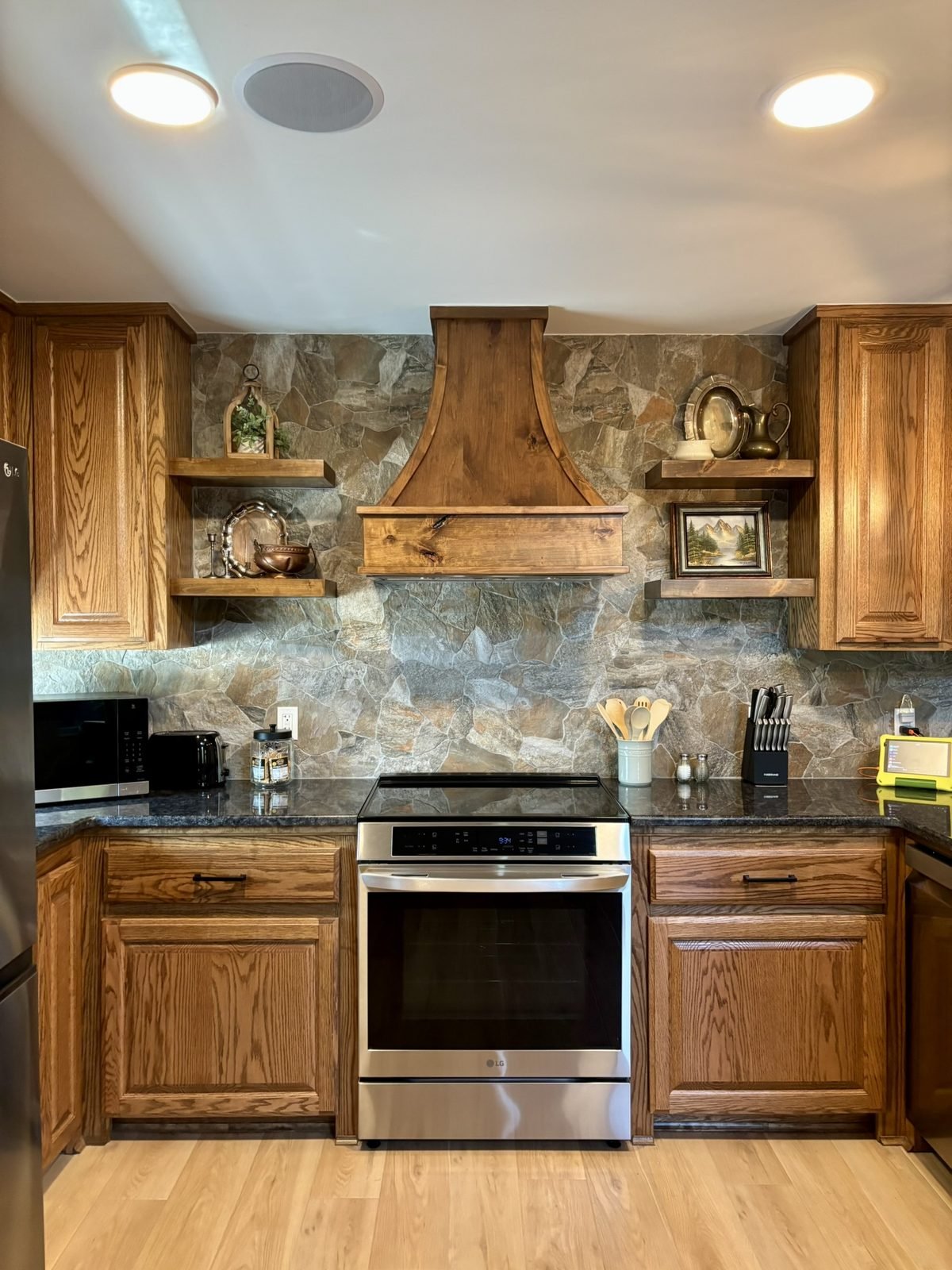 The kitchen with stone backsplash and induction range